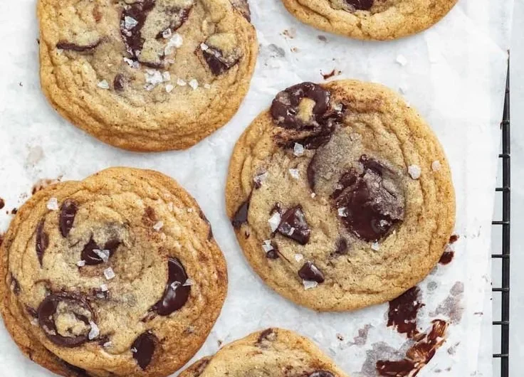 Deliciously chewy chocolate chip cookies on a wooden platter