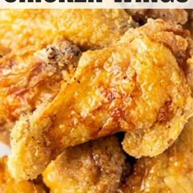 Crispy air fryer chicken wings garnished with herbs and served in a bowl