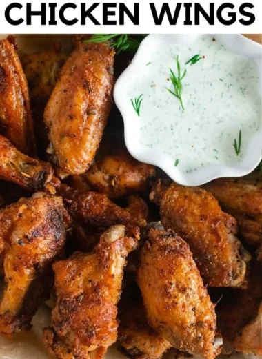 Plate of crispy baked chicken wings with dipping sauce
