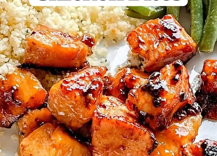 Honey Garlic Chicken Bites served on a plate with glaze and garnishes