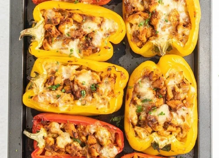 Colorful stuffed peppers filled with chicken, healthy ingredients, and seasonings.