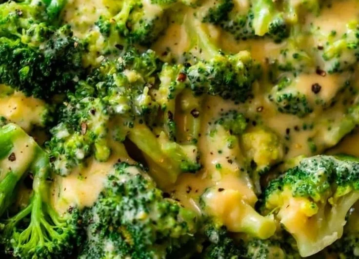Delicious cheesy broccoli dish garnished and ready to serve