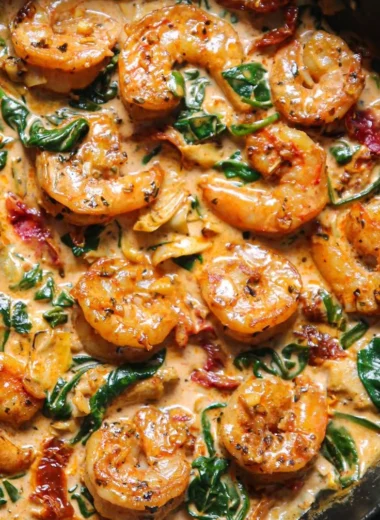 Delicious Tuscan shrimp dish with spinach and artichokes served in a bowl.