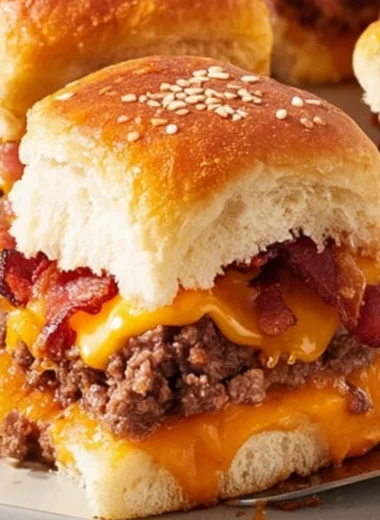 Bacon Cheeseburger Slider Bake served on a platter with melted cheese and crispy bacon.