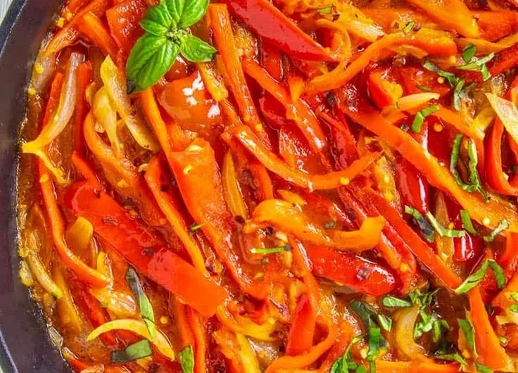 Delicious bowl of bell pepper stew with assorted vegetables and herbs