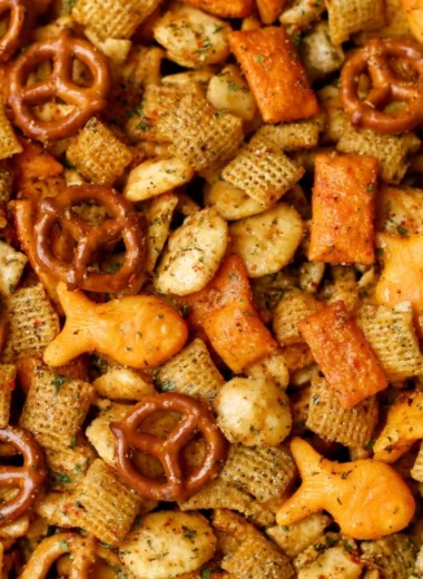 Bowl of Cheesy Ranch Chex Mix with crunchy snacks and ranch seasoning.