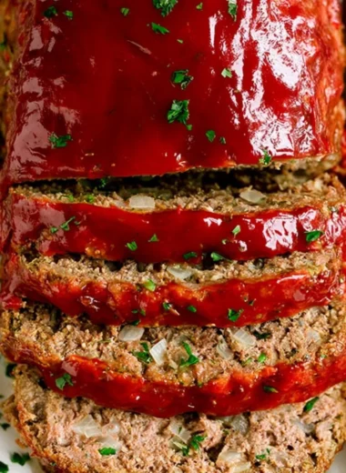 Delicious classic meatloaf served with mashed potatoes and green beans