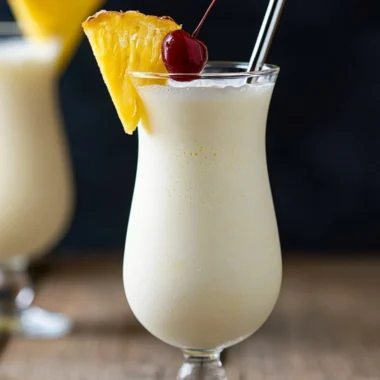 Classic Piña Colada cocktail with coconut, pineapple, and rum served in a glass.