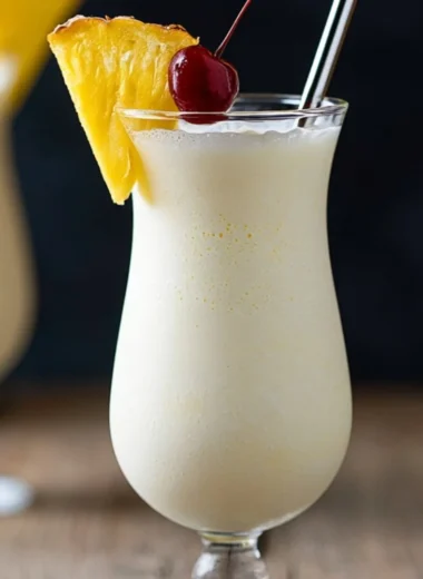 Classic Piña Colada cocktail with coconut, pineapple, and rum served in a glass.