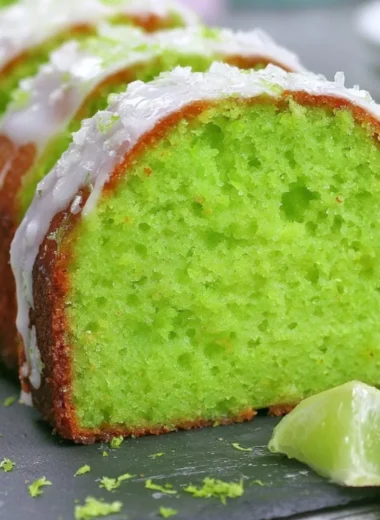 Cozy Key Lime Poke Cake topped with whipped cream and lime zest