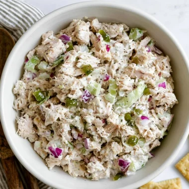 Delicious cozy rotisserie chicken salad served in a bowl with fresh greens.