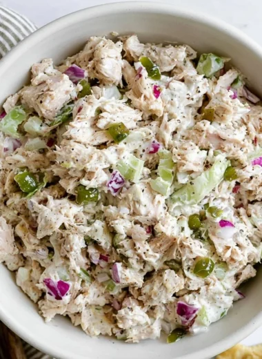 Delicious cozy rotisserie chicken salad served in a bowl with fresh greens.