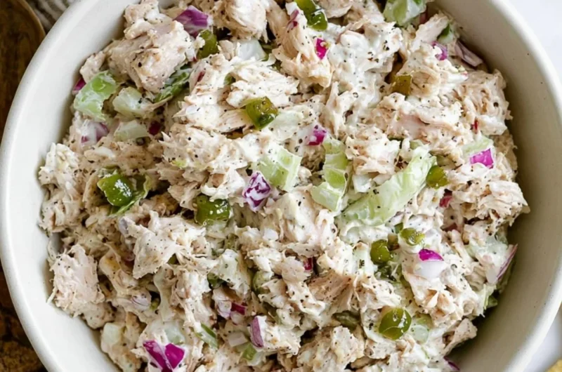 Delicious cozy rotisserie chicken salad served in a bowl with fresh greens.