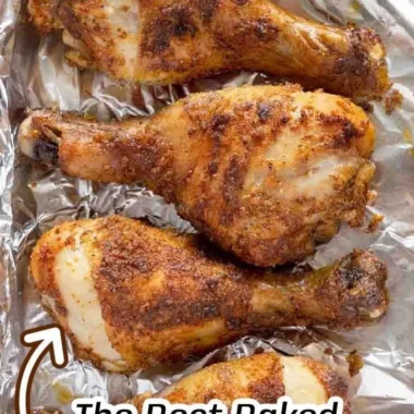 Crispy baked chicken legs served on a plate with herbs and spices