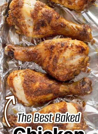 Crispy baked chicken legs served on a plate with herbs and spices
