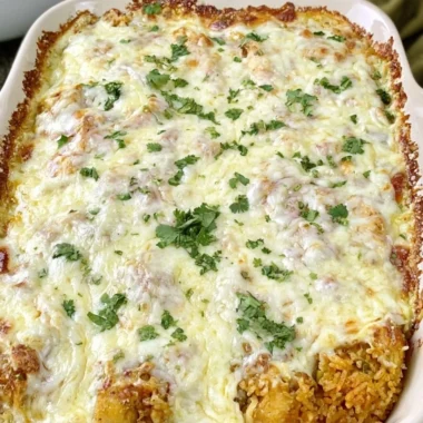 Dump and bake queso chicken and rice dish with melted cheese and vibrant colors