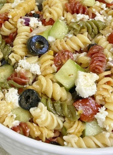 Bowl of colorful Easy Italian Pasta Salad with fresh vegetables and dressing