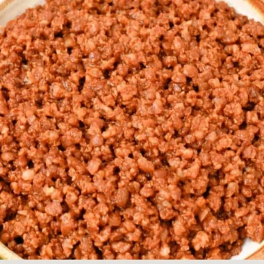 Bowl of easy lentil taco meat served with taco shells and fresh toppings.