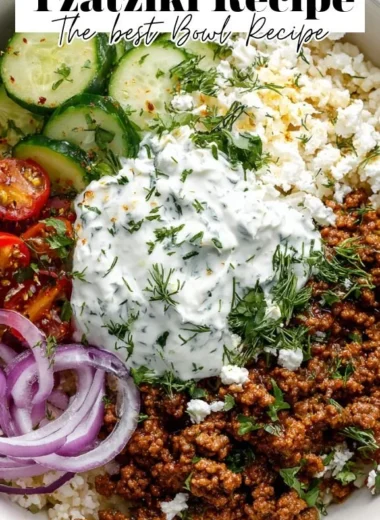 Greek Ground Beef Bowl topped with Tzatziki sauce and fresh vegetables