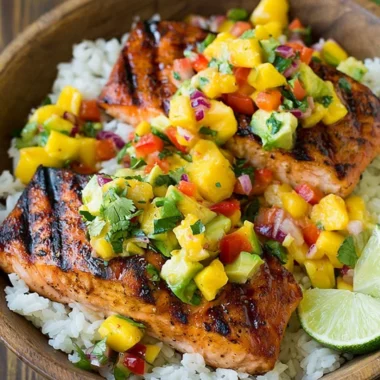 Grilled salmon with mango salsa and coconut rice on a plate