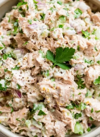 Healthy tuna salad with fresh vegetables and dressing on a plate