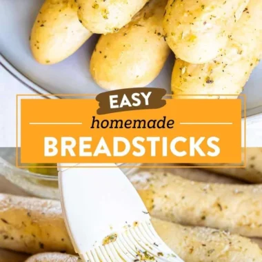 Plate of homemade garlic herb breadsticks with herbs and garlic butter
