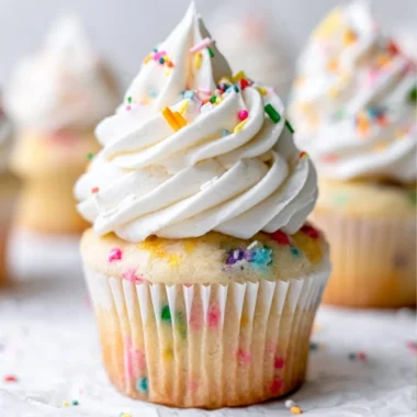 Delicious homemade vanilla cupcakes on a decorative plate