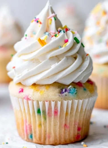 Delicious homemade vanilla cupcakes on a decorative plate