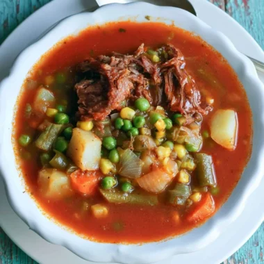 A bowl of My Mom's Old-Fashioned Vegetable Beef Soup with colorful vegetables and tender beef.