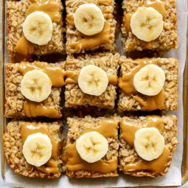 Peanut Butter Banana Baked Oatmeal in a serving dish, topped with banana slices and peanut butter.