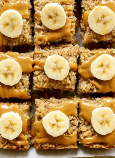 Peanut Butter Banana Baked Oatmeal in a serving dish, topped with banana slices and peanut butter.