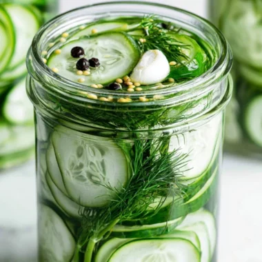 Homemade refrigerator dill pickles in a jar with fresh dill and garlic