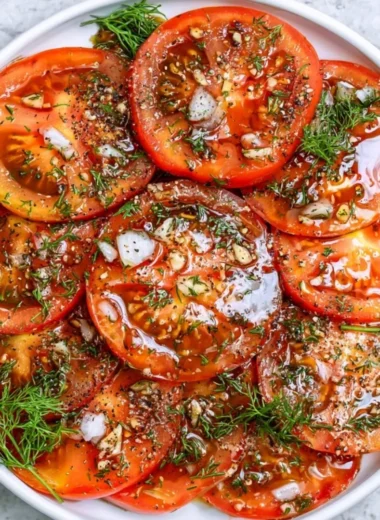 Fresh and colorful simple tomato salad with basil and olive oil