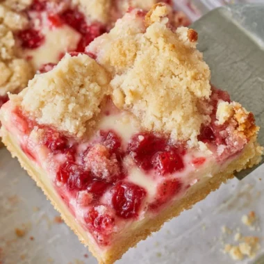 Delicious strawberry pie bars topped with fresh strawberries and cream
