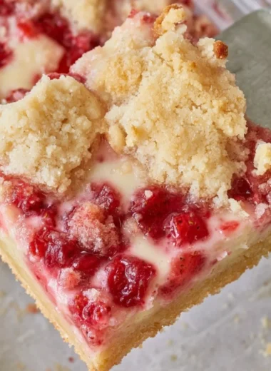 Delicious strawberry pie bars topped with fresh strawberries and cream