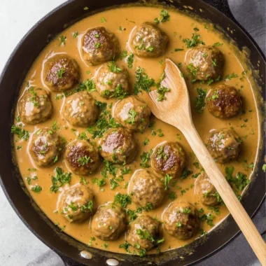 Plate of delicious Swedish meatballs served with creamy sauce and lingonberry jam