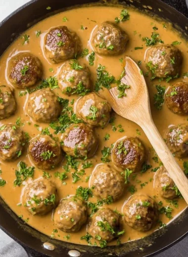 Plate of delicious Swedish meatballs served with creamy sauce and lingonberry jam