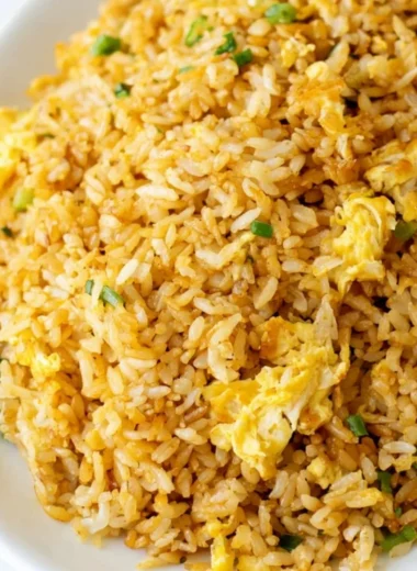 Bowl of cozy easy fried rice garnished with vegetables and herbs