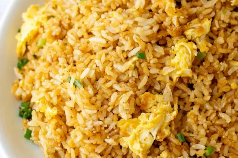 Bowl of cozy easy fried rice garnished with vegetables and herbs