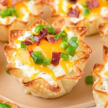 Cozy jalapeño popper wonton cups featuring creamy filling and crispy wrappers.