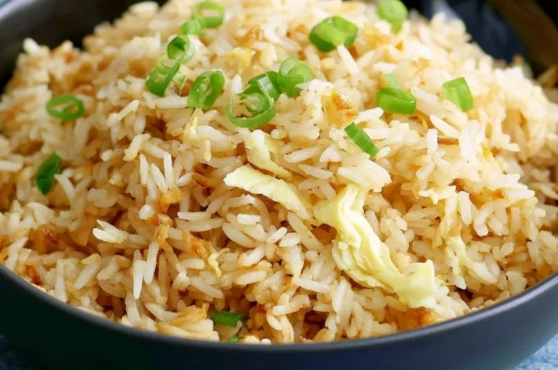 Delicious garlic fried rice served in a bowl with fresh herbs