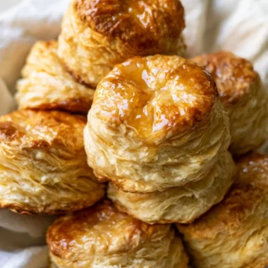 Freshly baked homemade buttermilk biscuits on a wooden table
