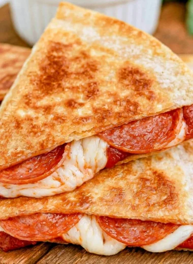 Cheesy pizza quesadillas with toppings ready to be served.