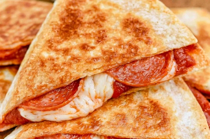 Cheesy pizza quesadillas with toppings ready to be served.
