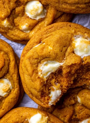 Delicious Pumpkin White Chocolate Chip Cookies on a wooden table.
