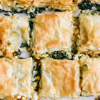 Delicious homemade spinach pie sliced and served on a plate