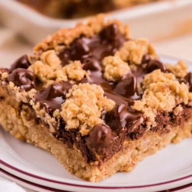 Cozy chocolate peanut butter oatmeal bars stacked on a plate