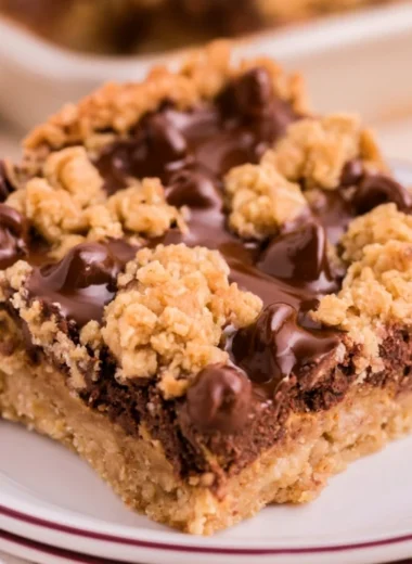 Cozy chocolate peanut butter oatmeal bars stacked on a plate
