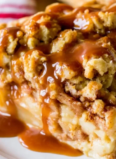 Slice of Dutch Caramel Apple Pie with caramel drizzle and apple filling