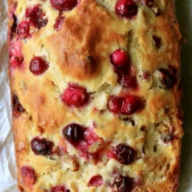Sliced Mom's Cranberry Walnut Bread with cranberries and walnuts visible